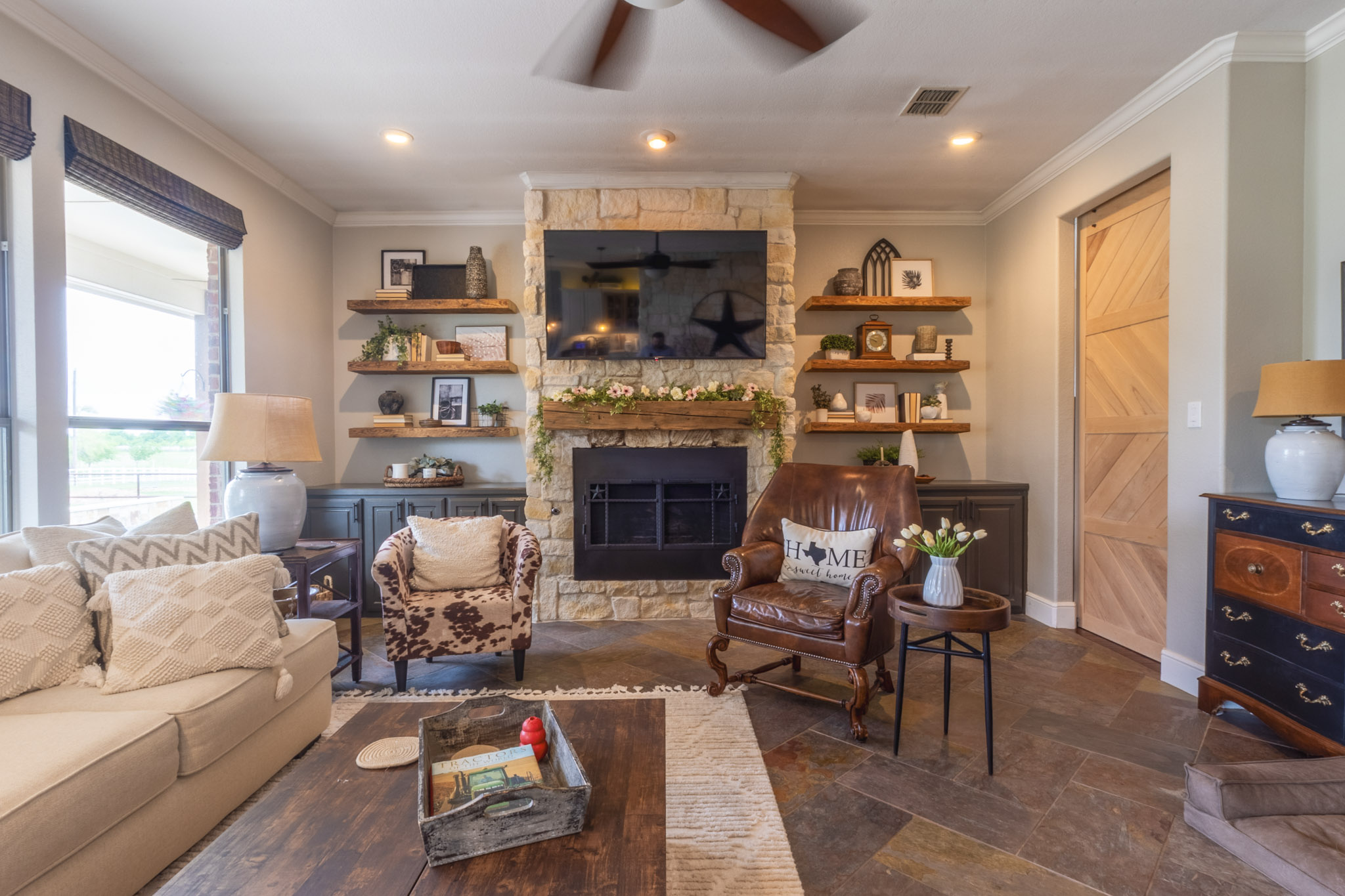 Remodeled living room with stone fireplace by CMA Flooring & Remodeling in Celina, Texas