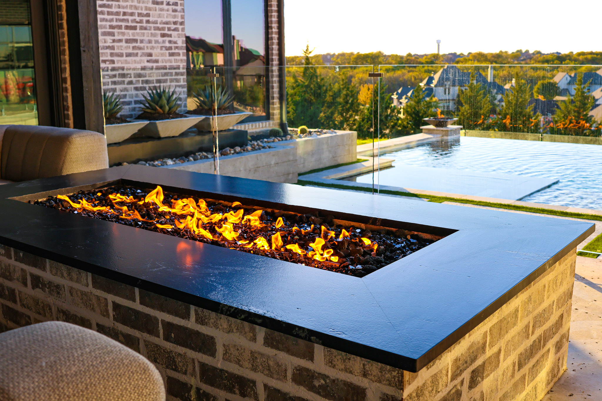 Linear fire table overlooking a vanishing-edge pool in Heath, Texas.