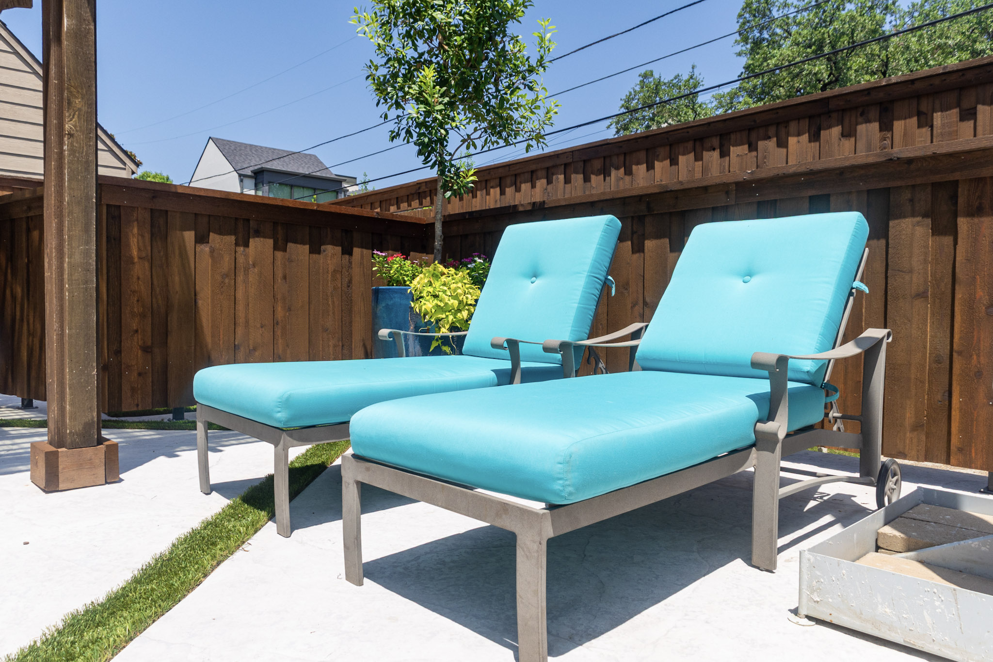 Turquoise poolside lounge chairs beside a custom pool in University Park, Texas