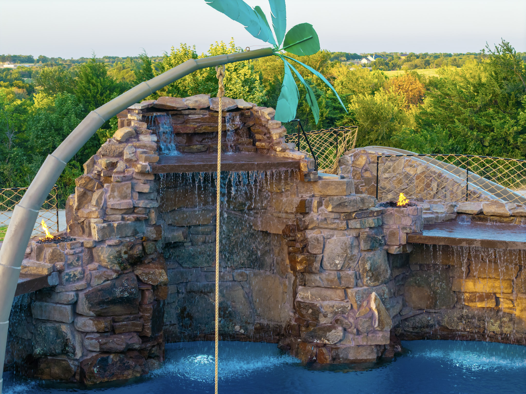 Massive rock pool waterfall with rope swing and multiple cascades.