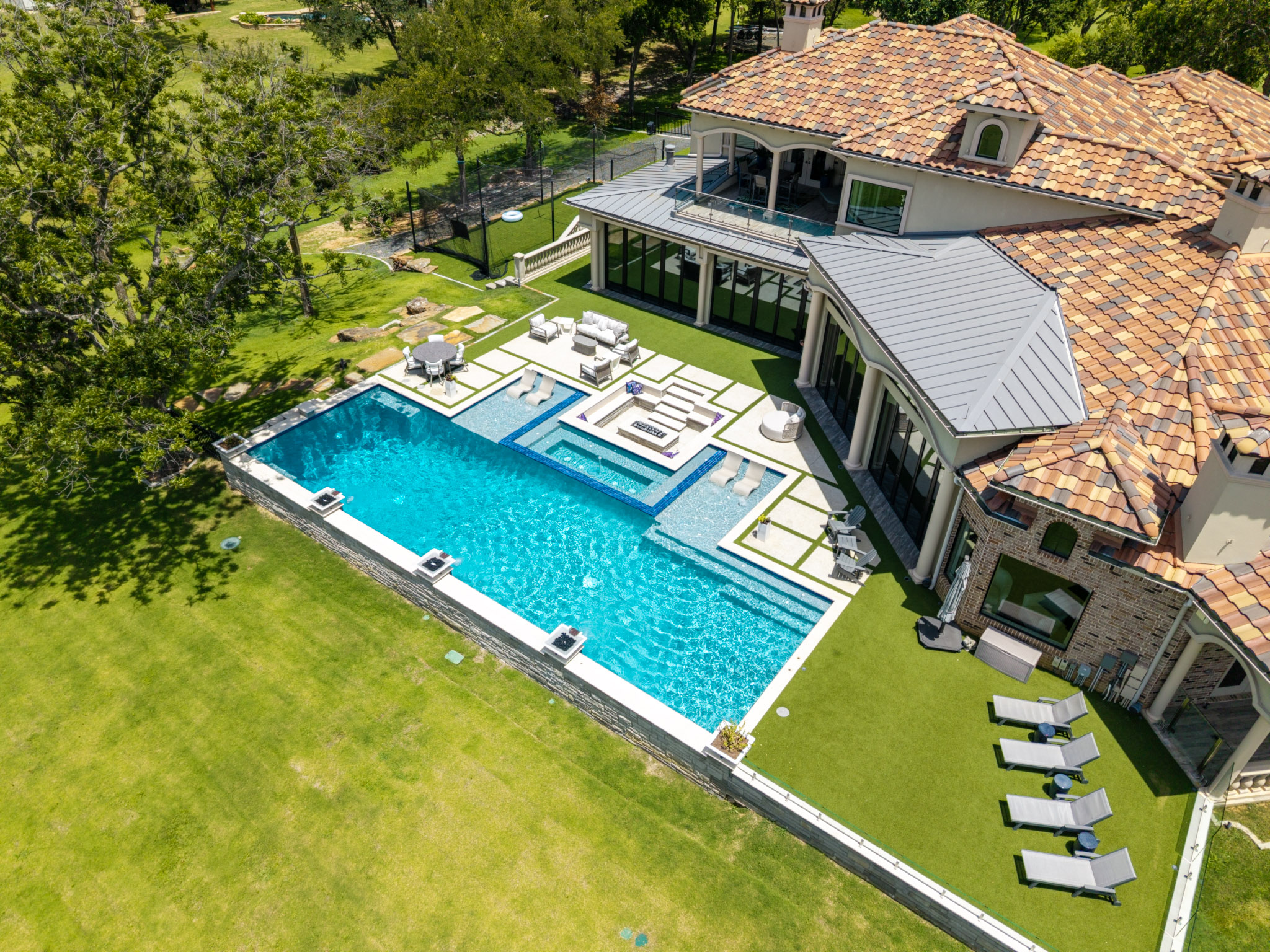 Custom lakefront swimming pool with spa and tanning ledges near Lake Lewisville