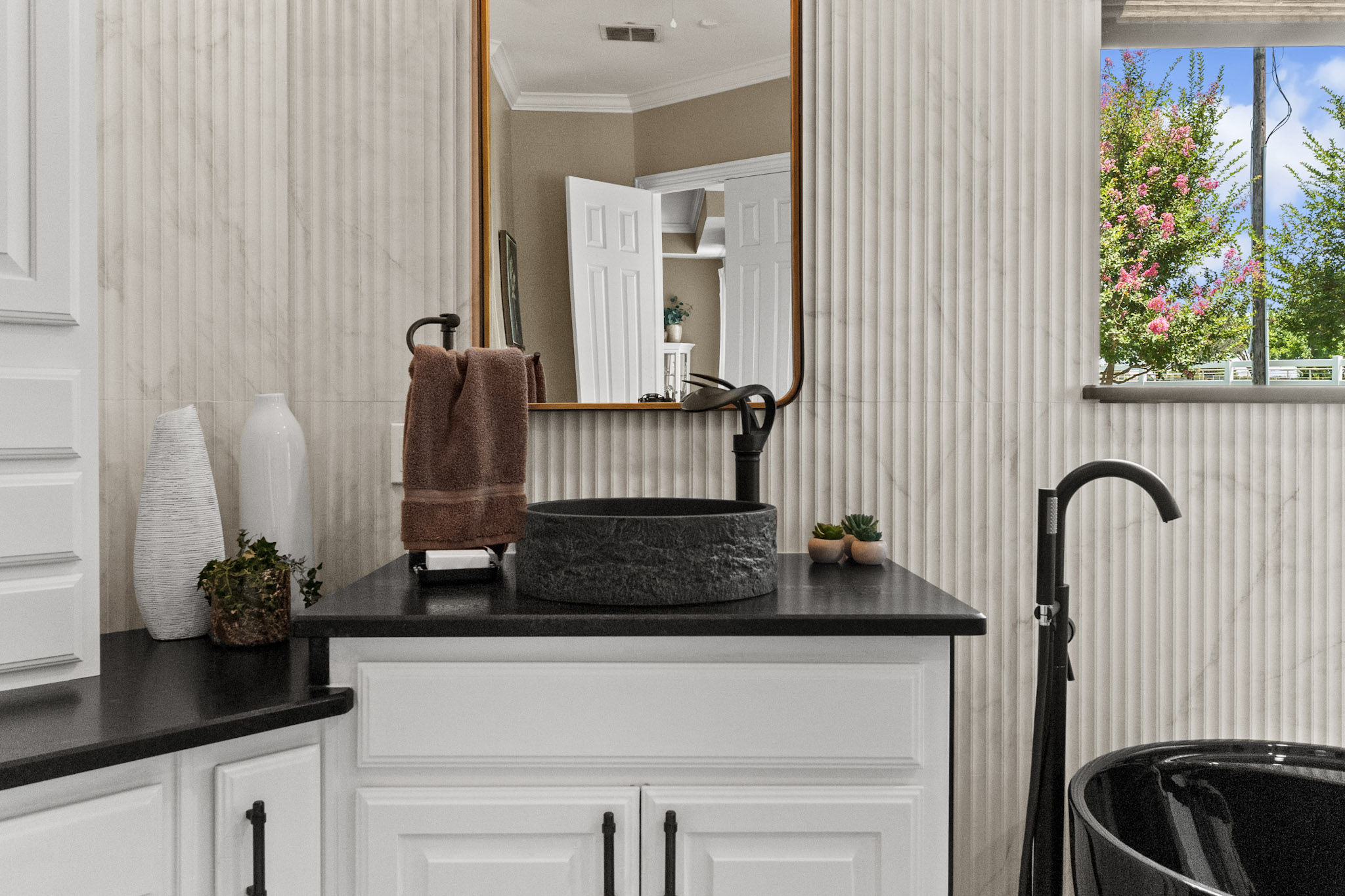Bathroom vanity with vessel sink and matte black fixtures in Celina, Texas