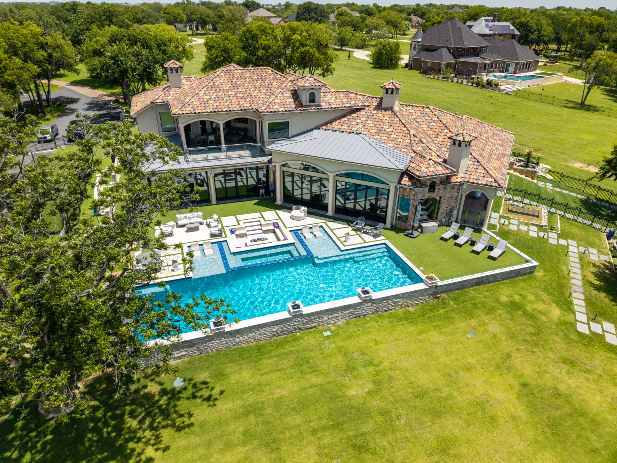 Aerial view of Gold Medal Pools luxury lakefront pool in Lakewood Village, Texas