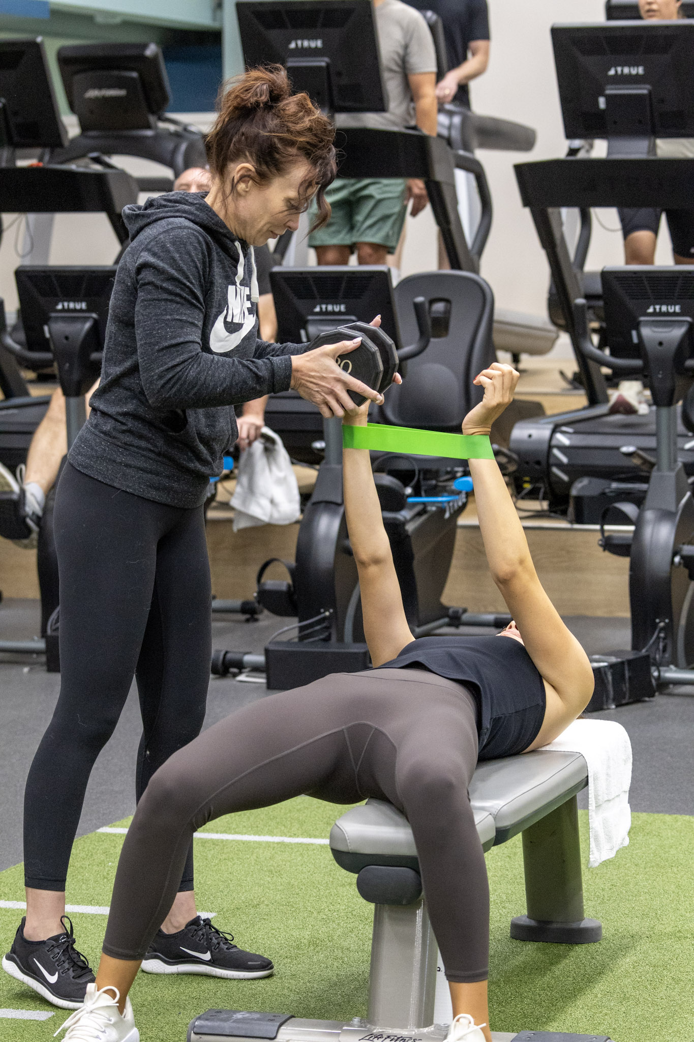 Athlete performing a standing resistance exercise on indoor turf at The Nelson Sports facility.