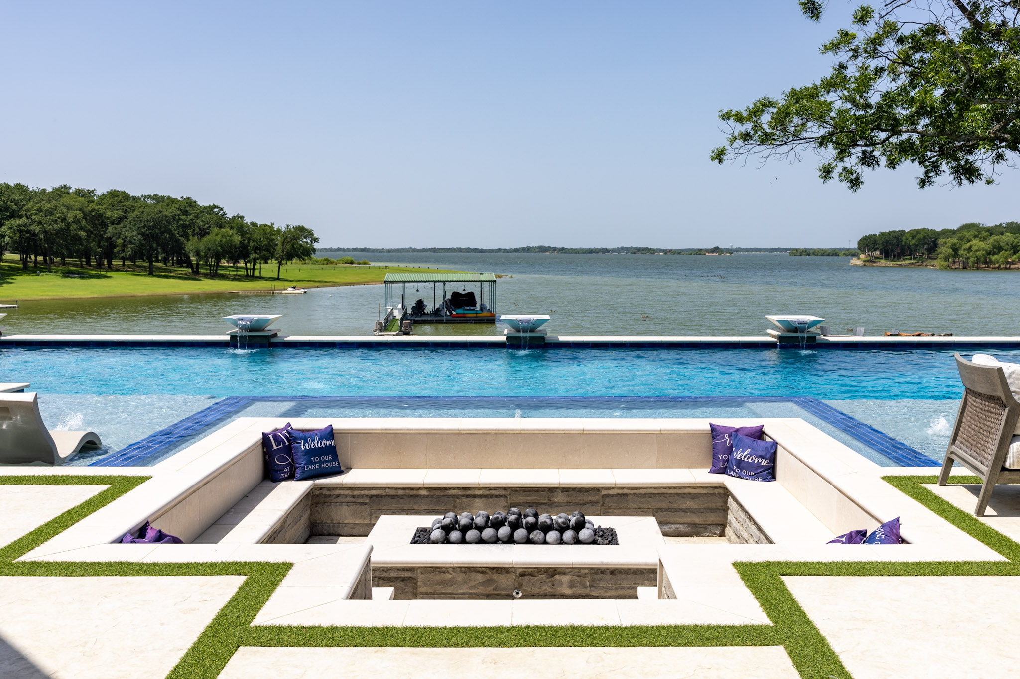 Sunken fire pit overlooking custom pool and Lake Lewisville in Lakewood Village