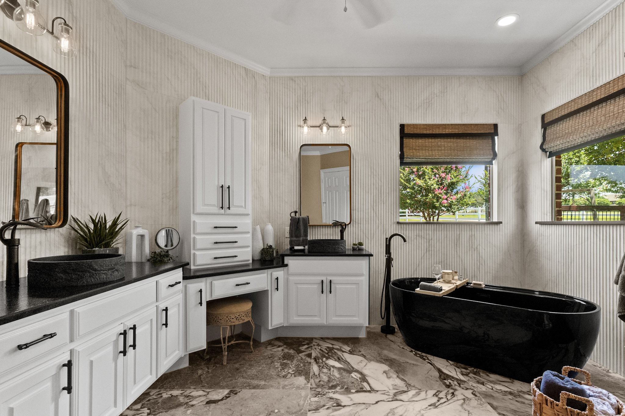 Luxury primary bathroom remodel with dual vanity and black soaking tub in Celina
