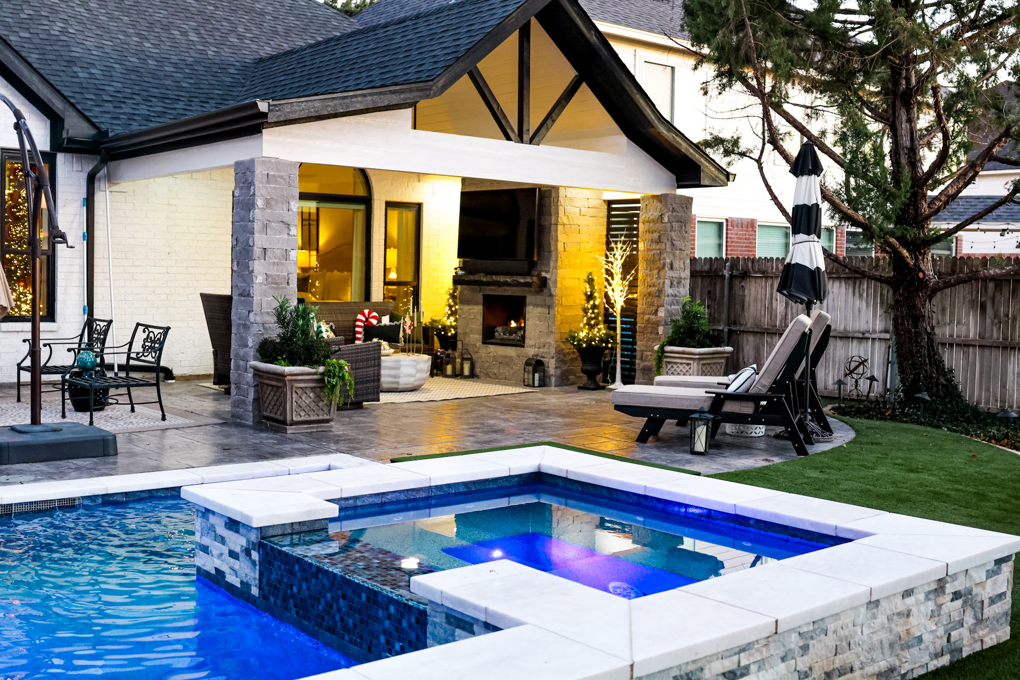 Raised square spa beside a rectangular pool with sheer descent and putting green.