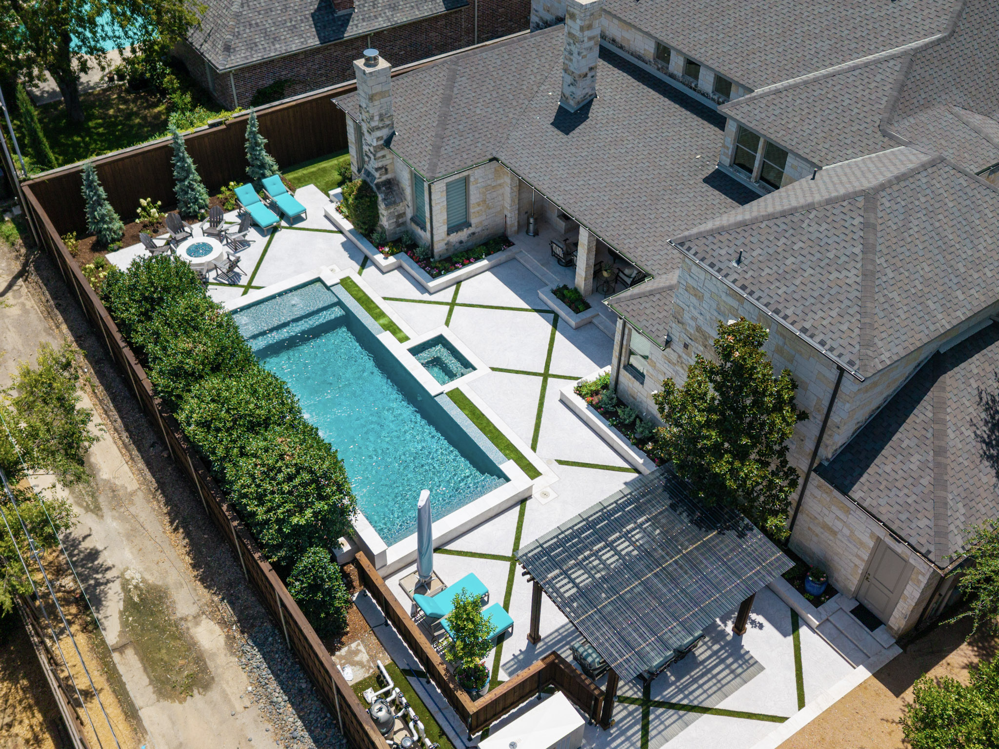 Drone view of luxury pool, spa and outdoor living area in University Park, TX