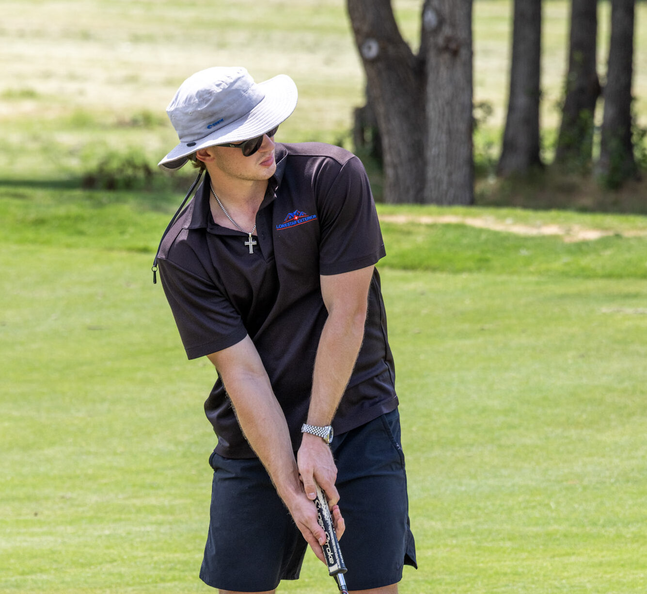 Golfer preparing a shot on the fairway during a golf event