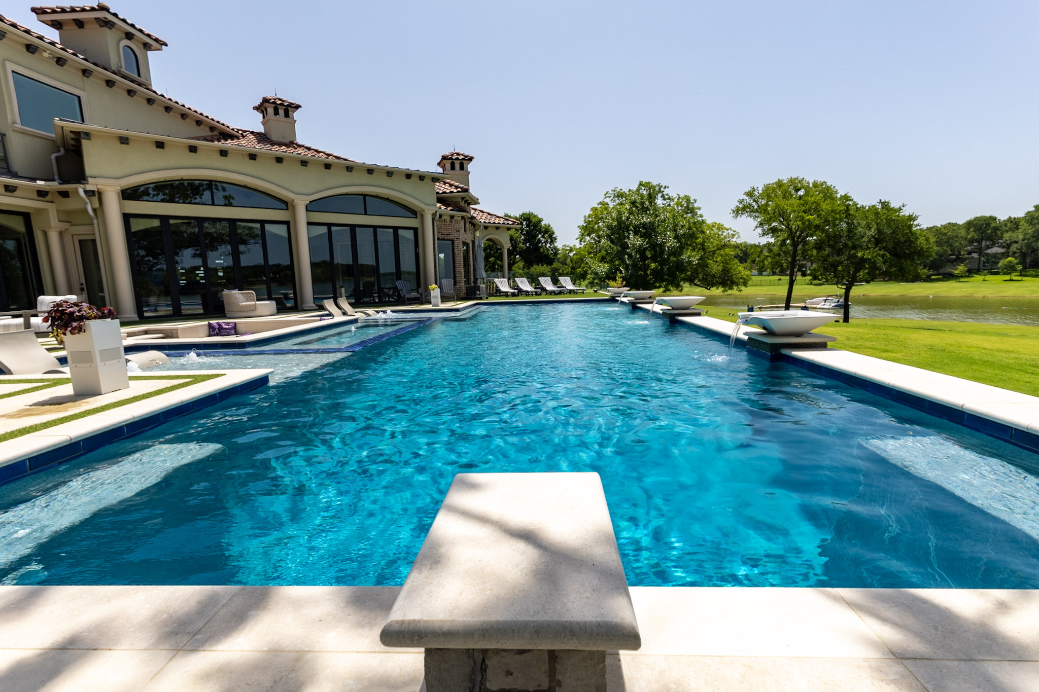 Luxury lakefront swimming pool with water features in Lakewood Village, Texas