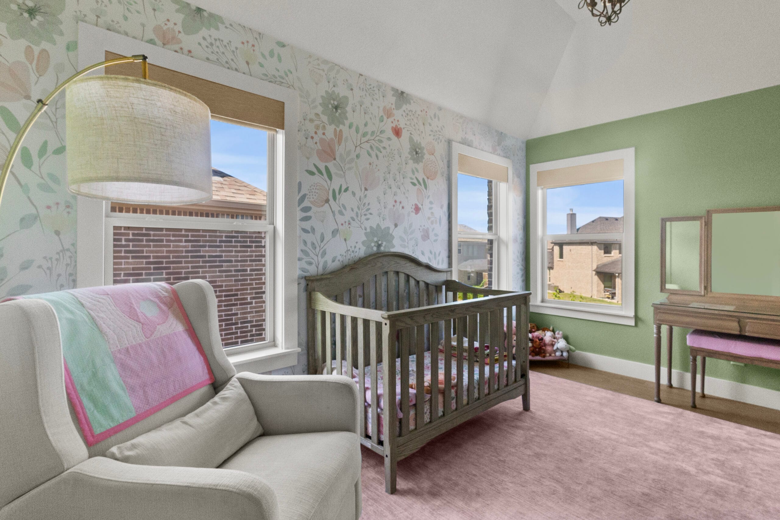 Nursery with white reading chair, wood crib and floral wallpaper in Prosper