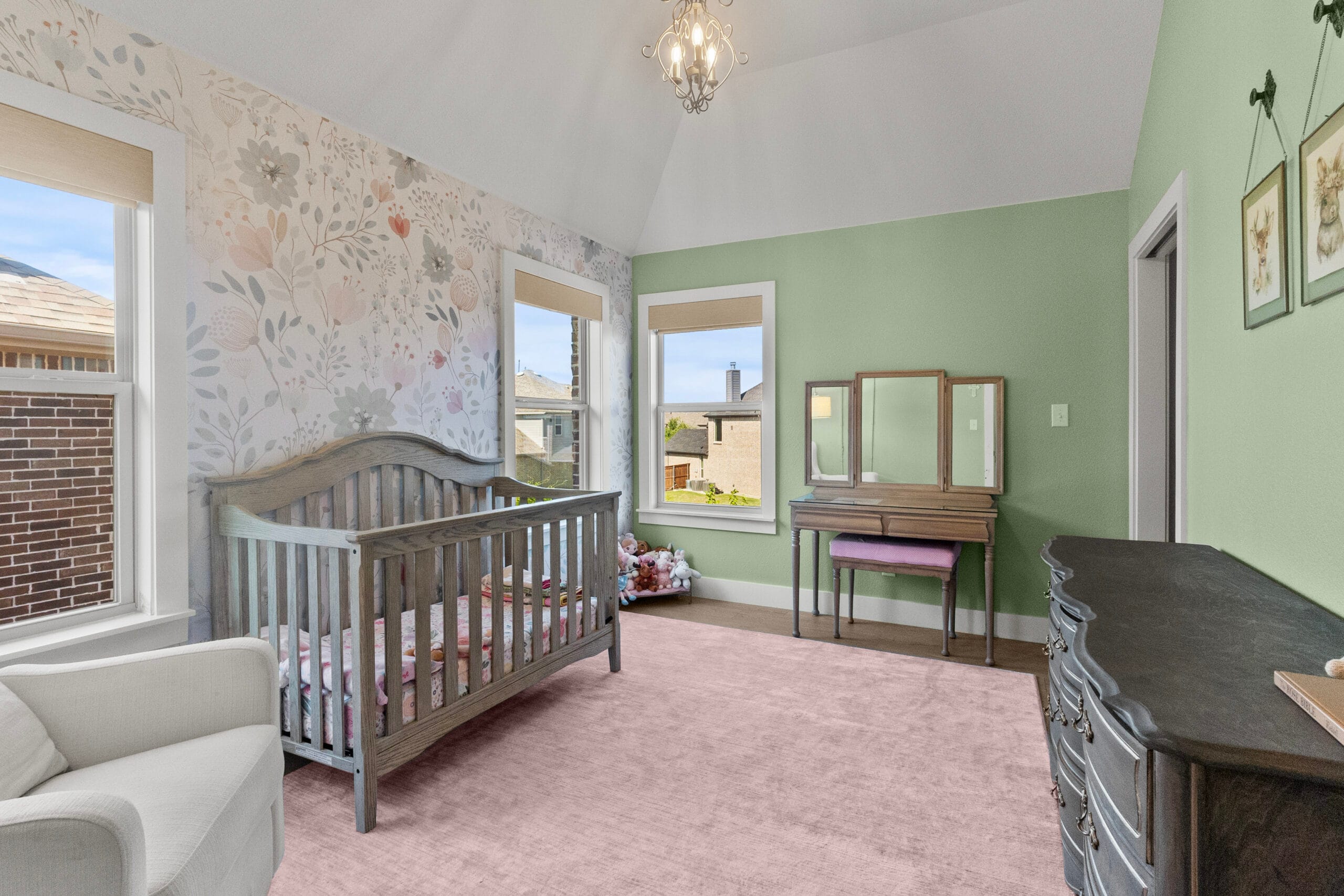 Nursery with floral wallpaper, wood crib and pink rug in Prosper, Texas