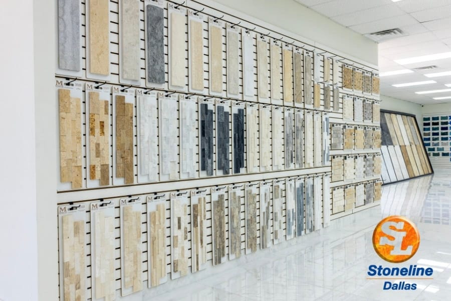 Large-format tile and stone samples displayed along a showroom wall
