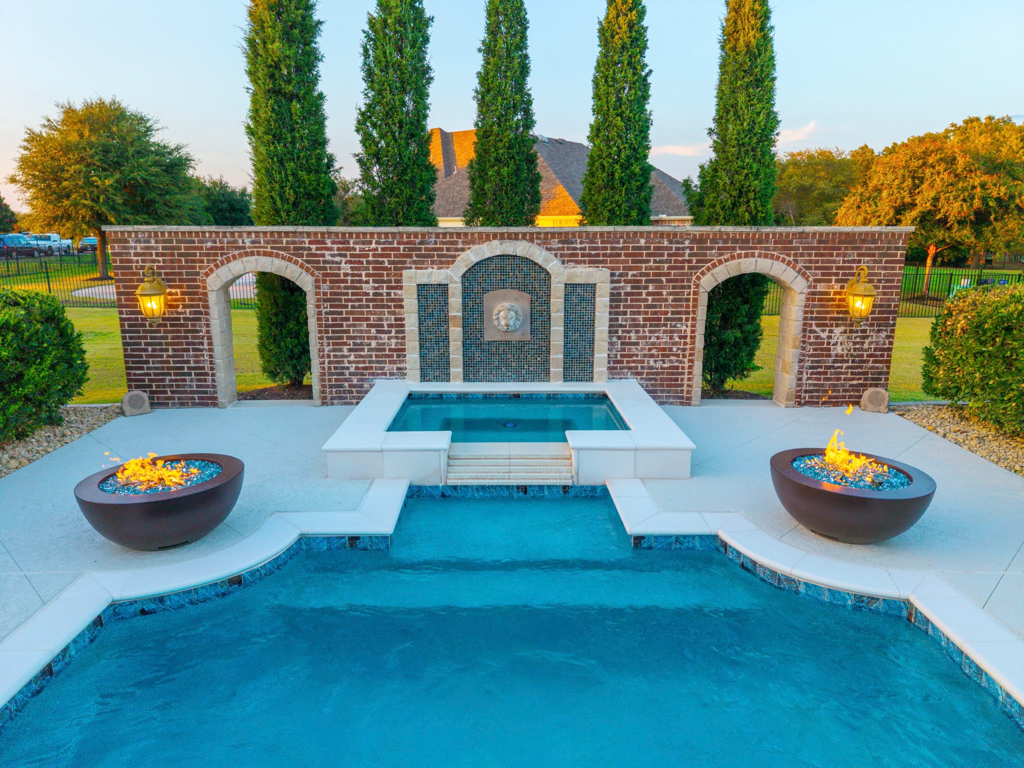Drone view of raised spa and twin fire bowls beside remodeled pool