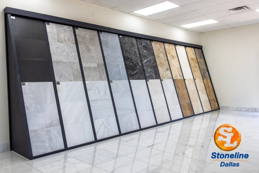 Wall of neutral stone and mosaic samples in commercial showroom