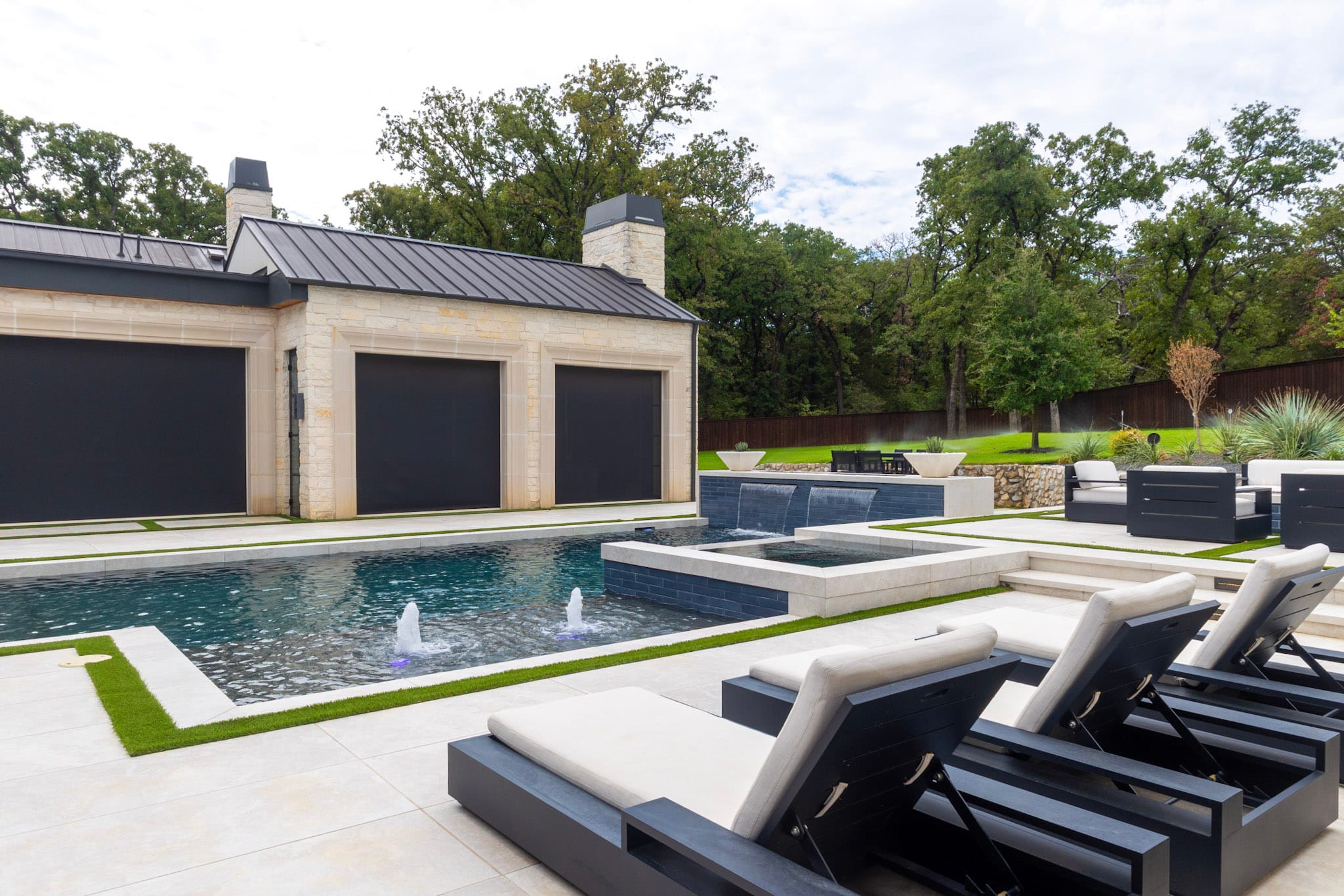 Luxury Southlake pool with spa, fountains and lounge chairs