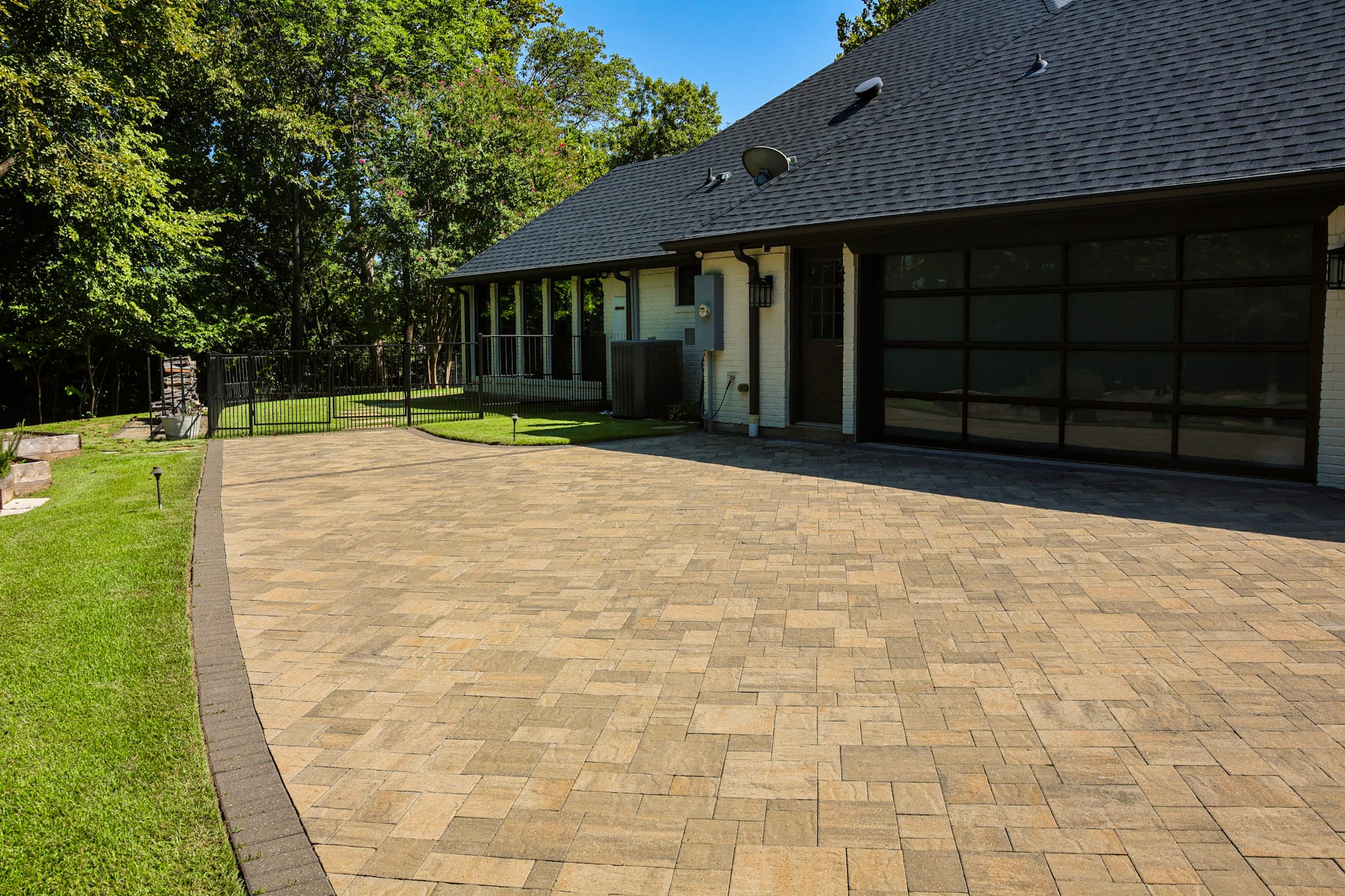 Finished Belgard paver driveway extending across the garage area of a Fairview home