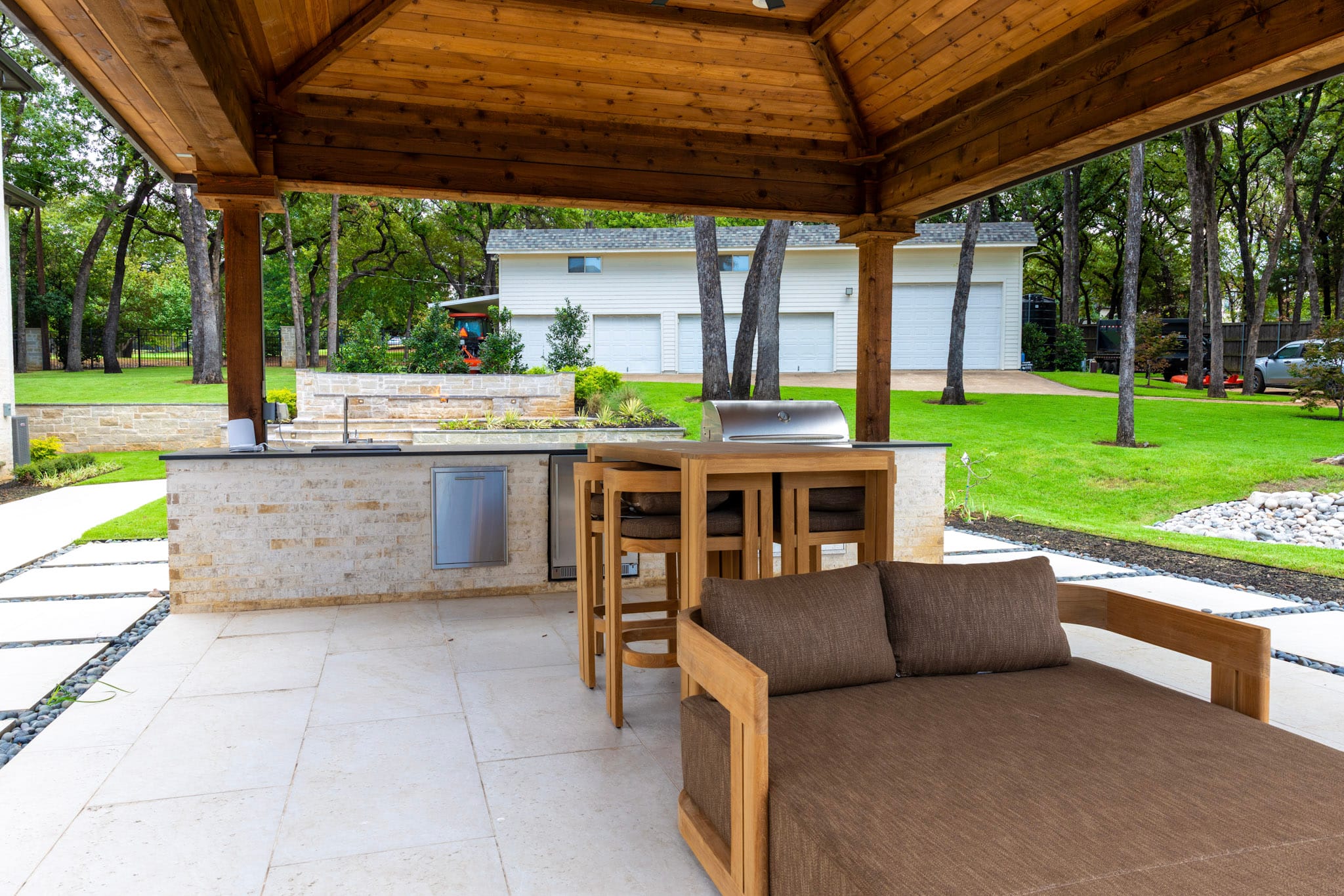 Circular turquoise tiled spa with swimming pool and covered wood pavilion in Southlake