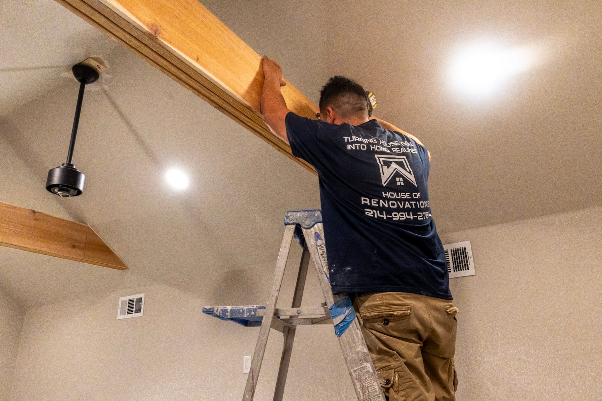 House of Renovations crew member completing interior finish work around a doorway