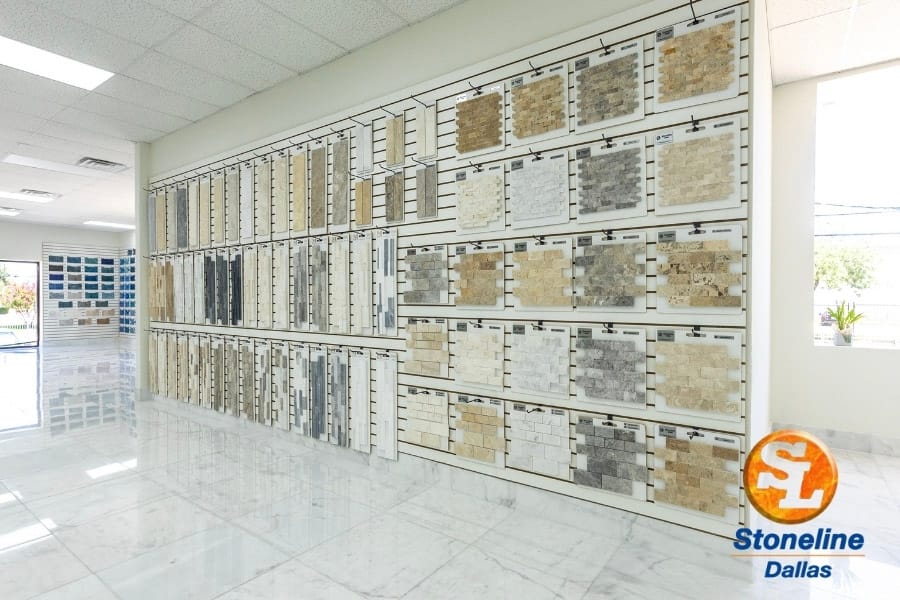 Stone and mosaic samples displayed on a showroom wall