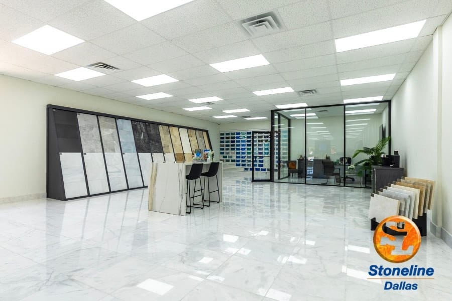 Wide interior view of StoneLine showroom with displays and glass office