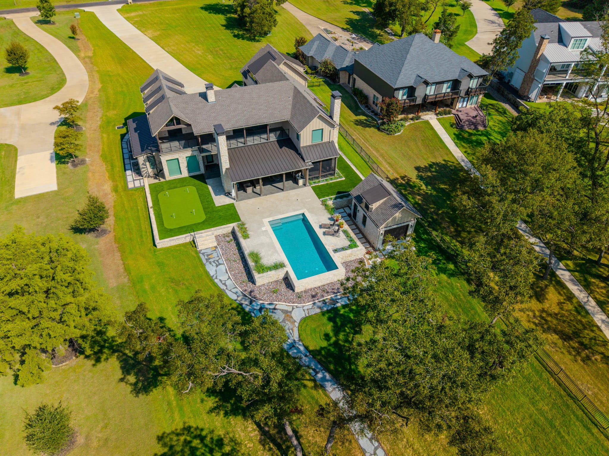 Drone view of lakefront residence, swimming pool, lawn, and Richland Chambers Reservoir