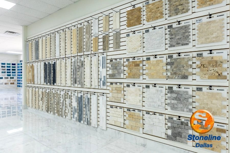 Wall-mounted stone and mosaic samples inside a Dallas showroom