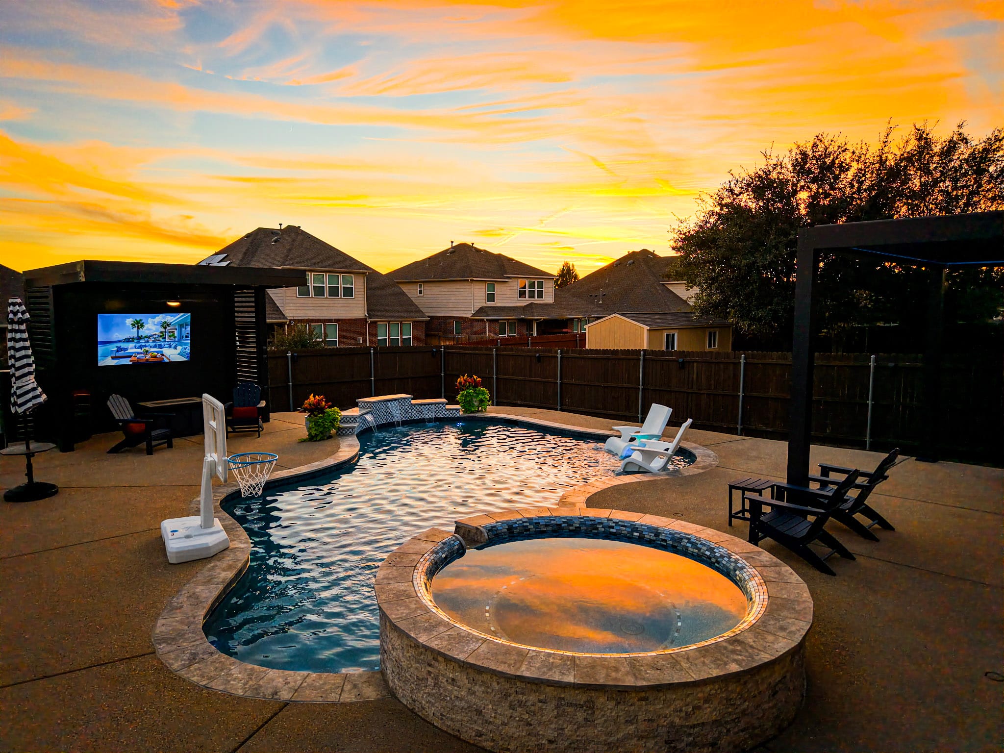 Aerial sunset view of Fort Worth backyard pool with circular raised spa