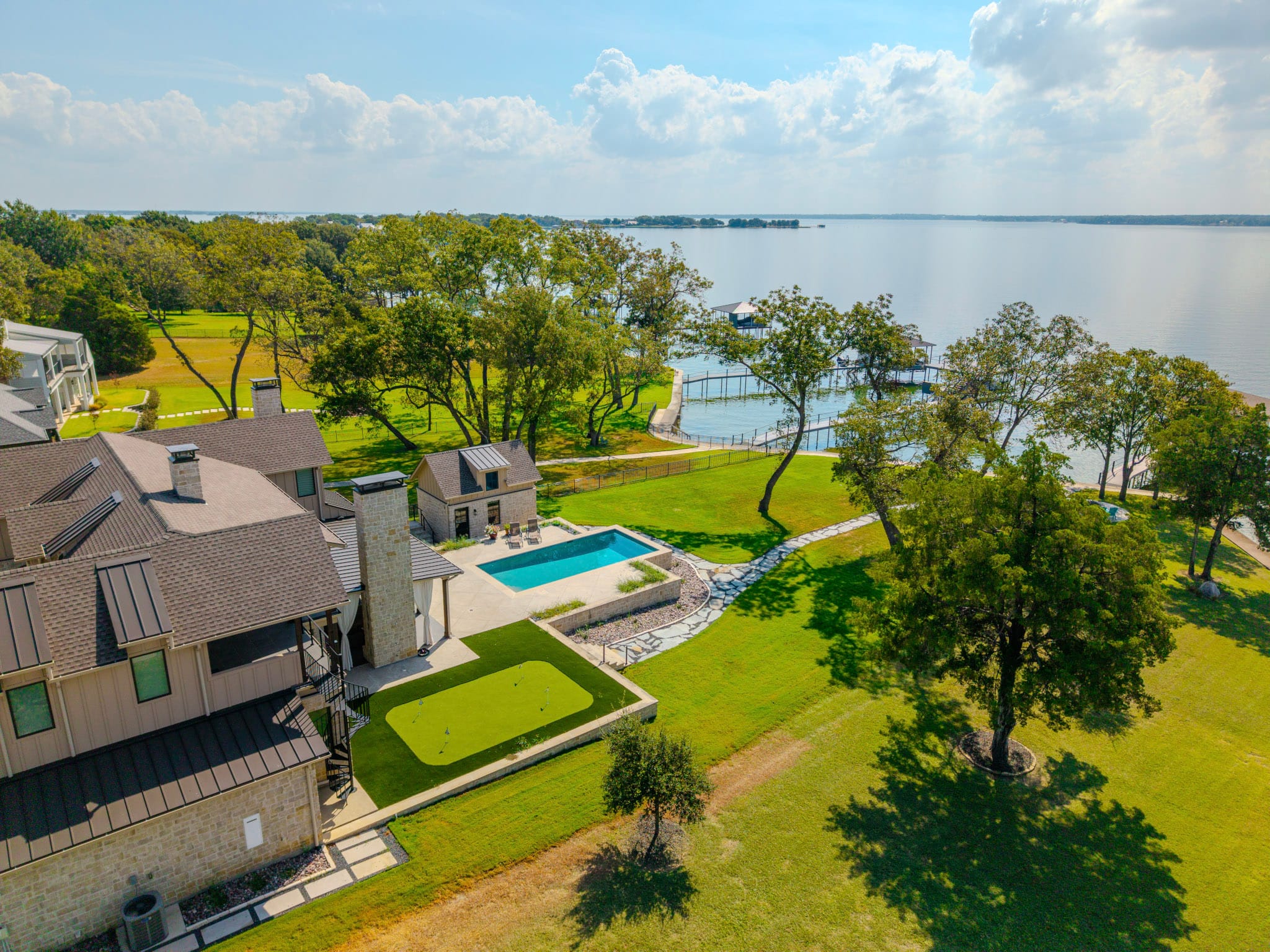 Aerial view of pool property surrounded by lawn and overlooking Richland Chambers Reservoir