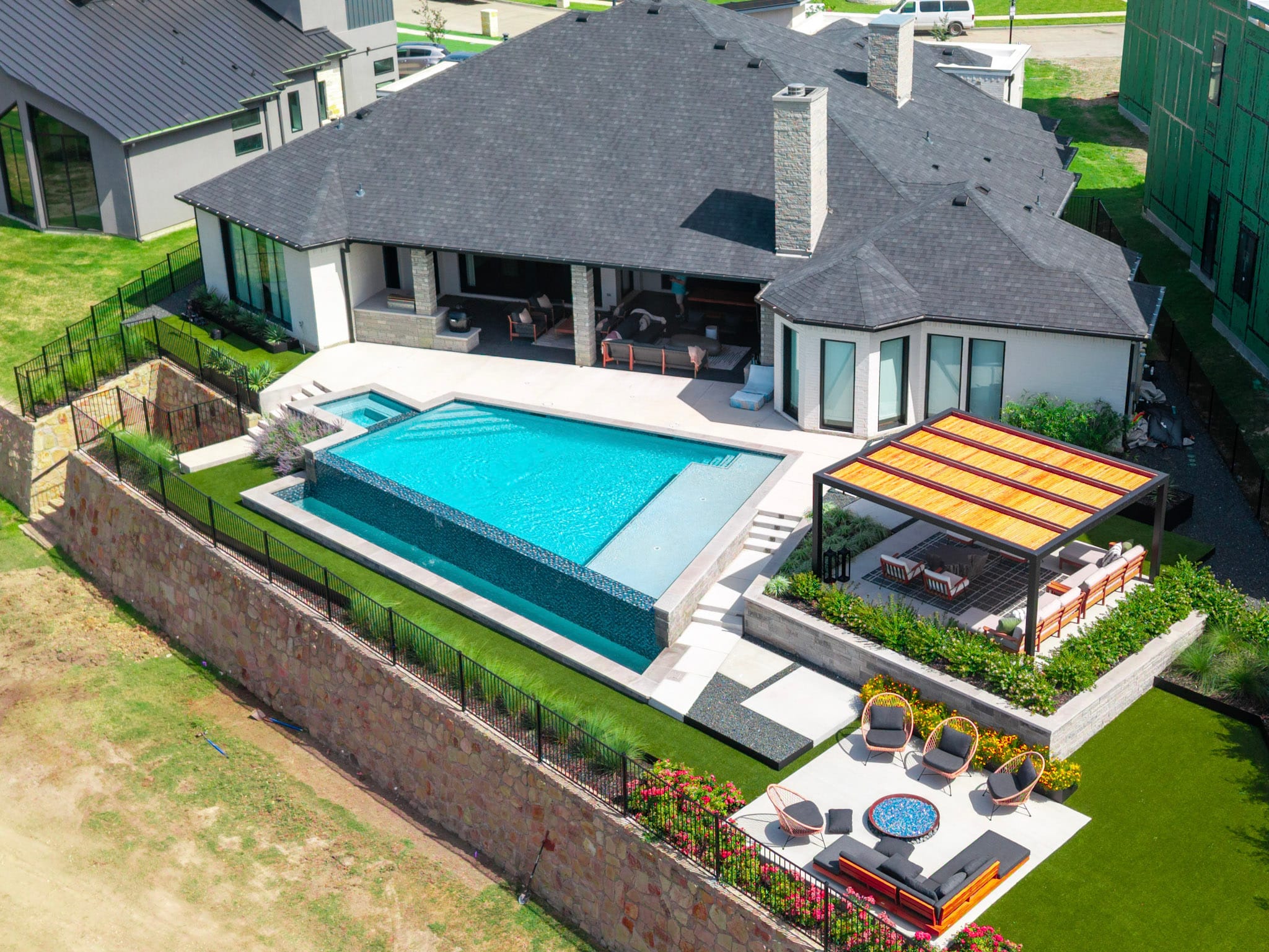 Wide aerial view of vanishing edge pool and outdoor living project in Heath Texas
