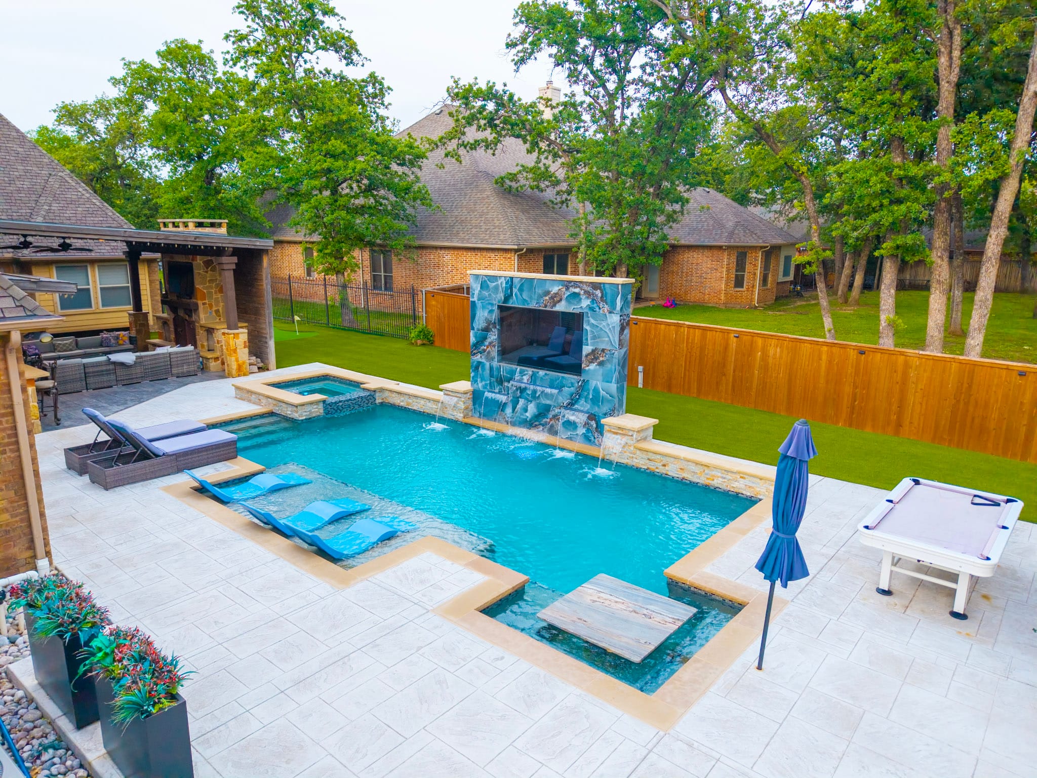Aerial view of custom pool spa water feature and outdoor living area in Fort Worth