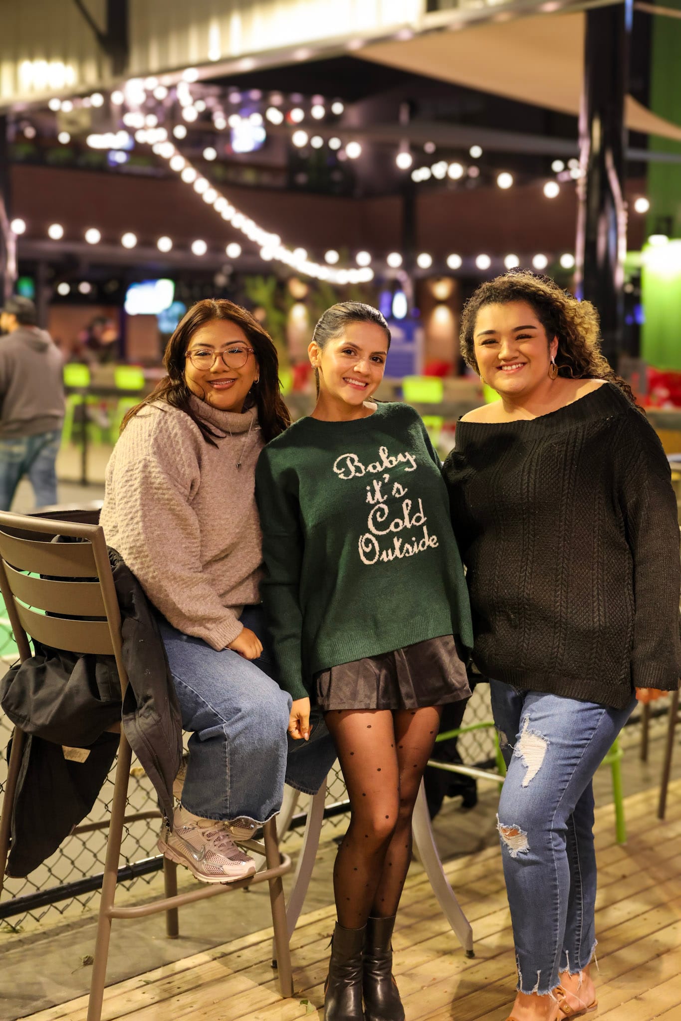 Three women posing together at a corporate event