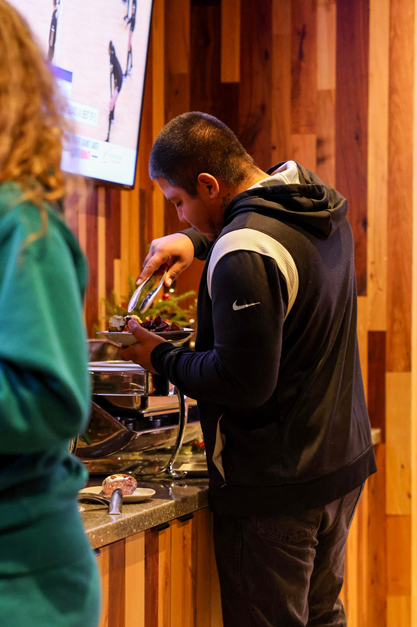 Man serving food from a buffet during a company event