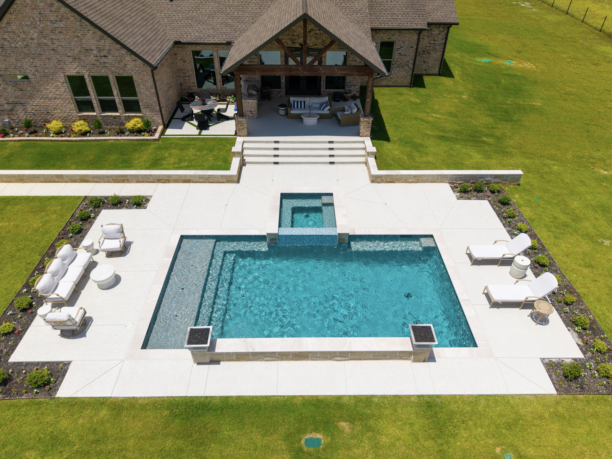 Aerial view of pool spa patio covered porch and rural property