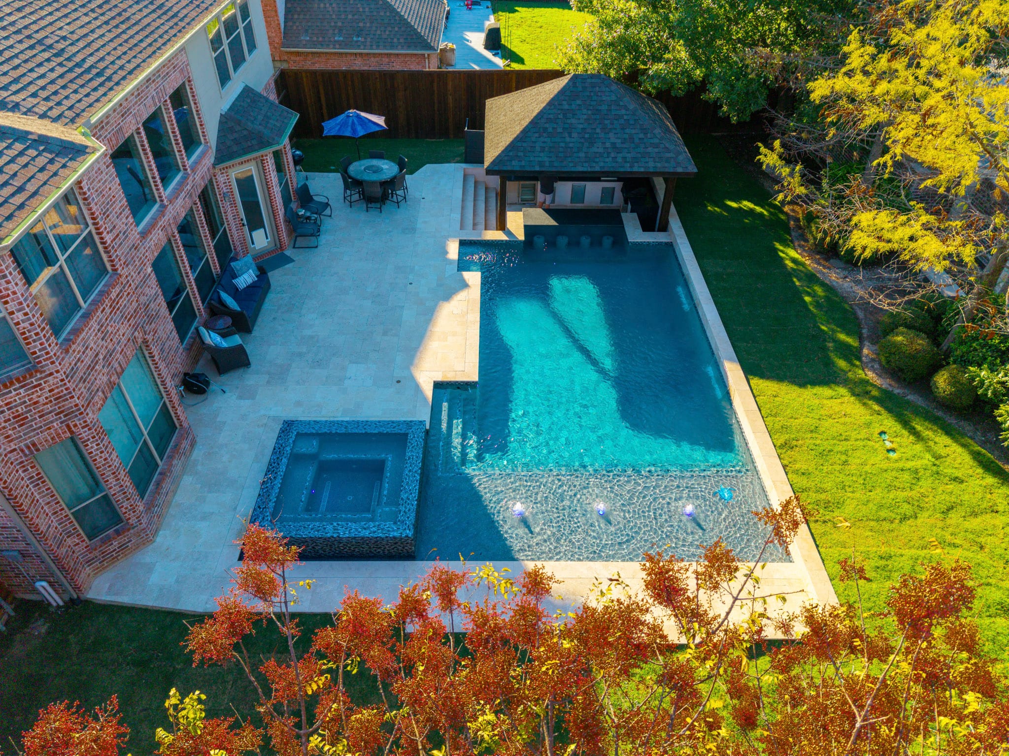 Aerial view of pool spa covered kitchen and backyard in Allen Texas