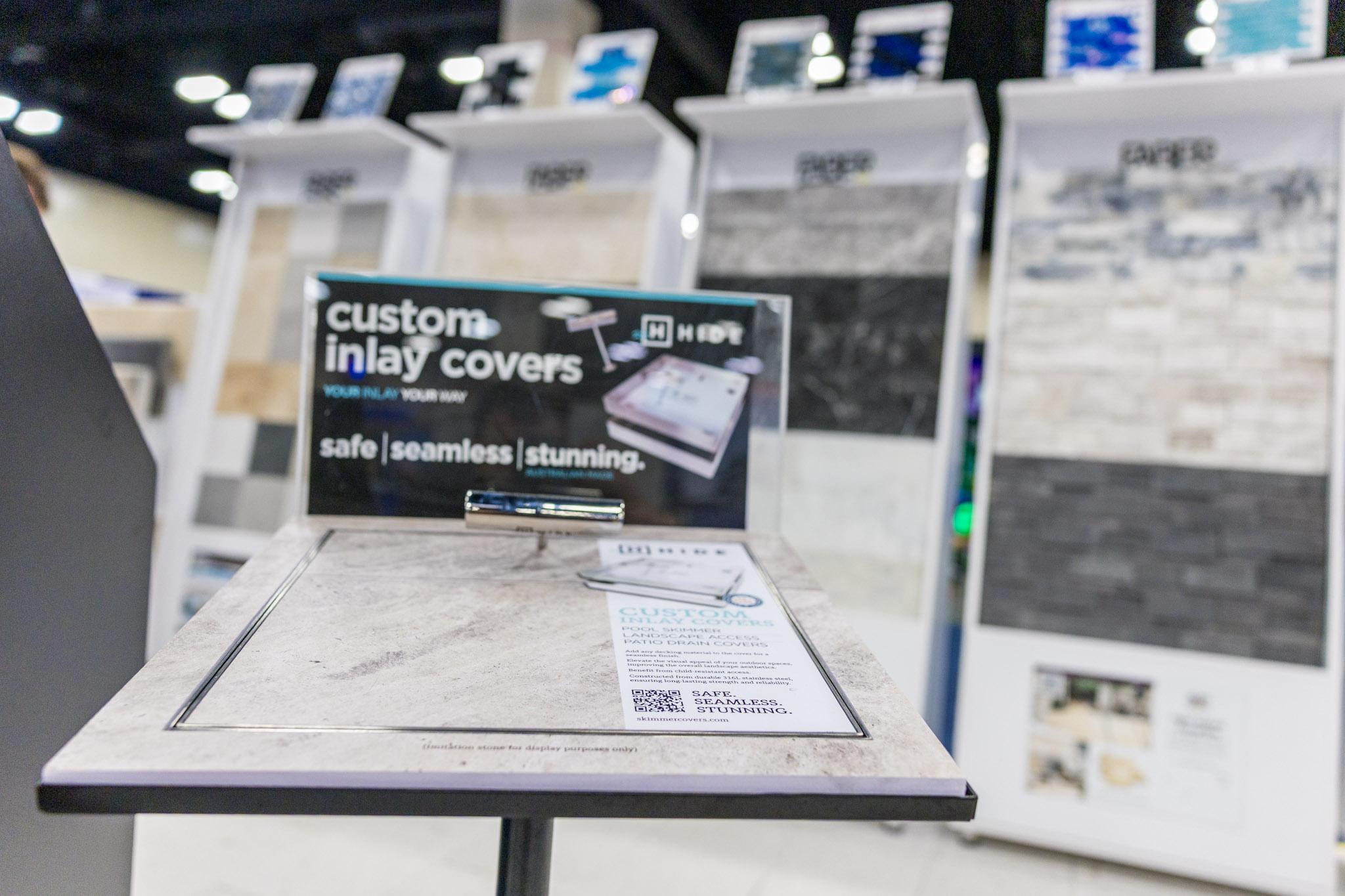 Custom inlay cover display with Faber CNK Stone product towers behind it