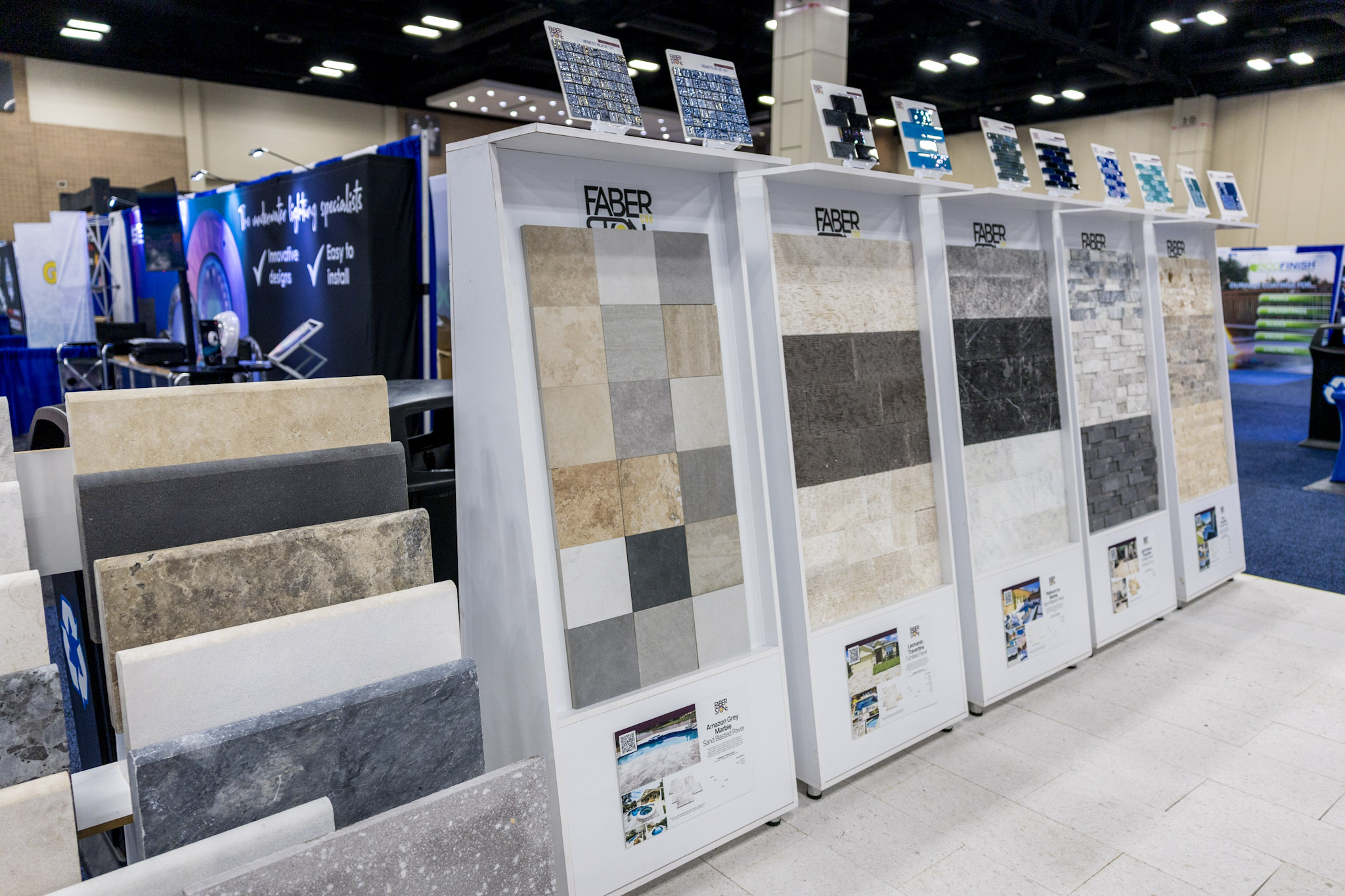 Row of Faber CNK Stone product display towers at a San Antonio trade show