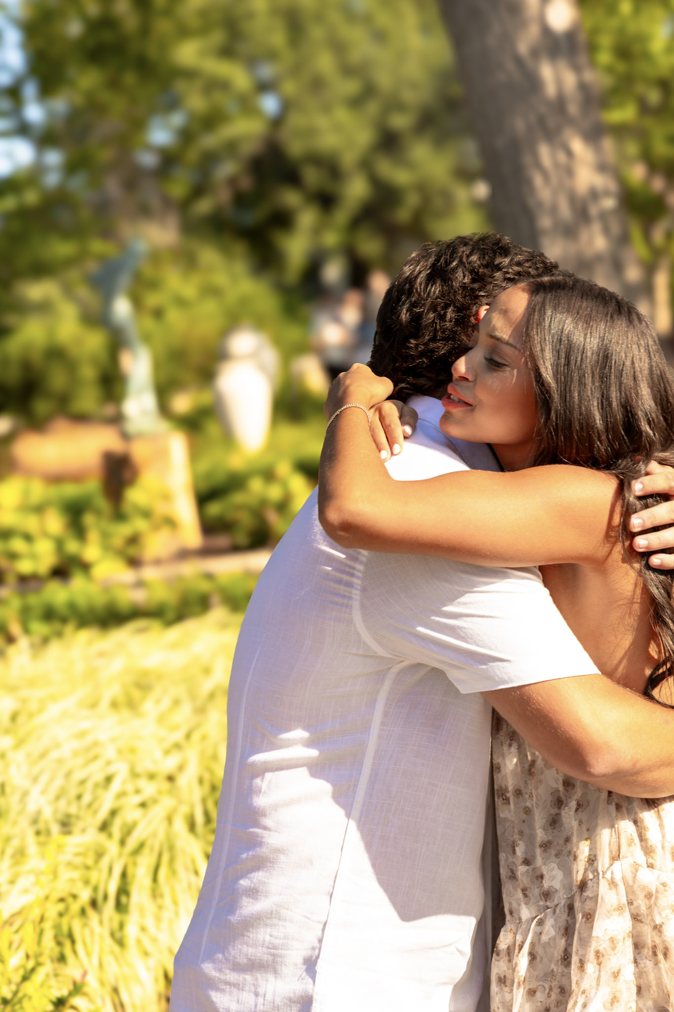 Newly engaged couple hugging closely after a proposal