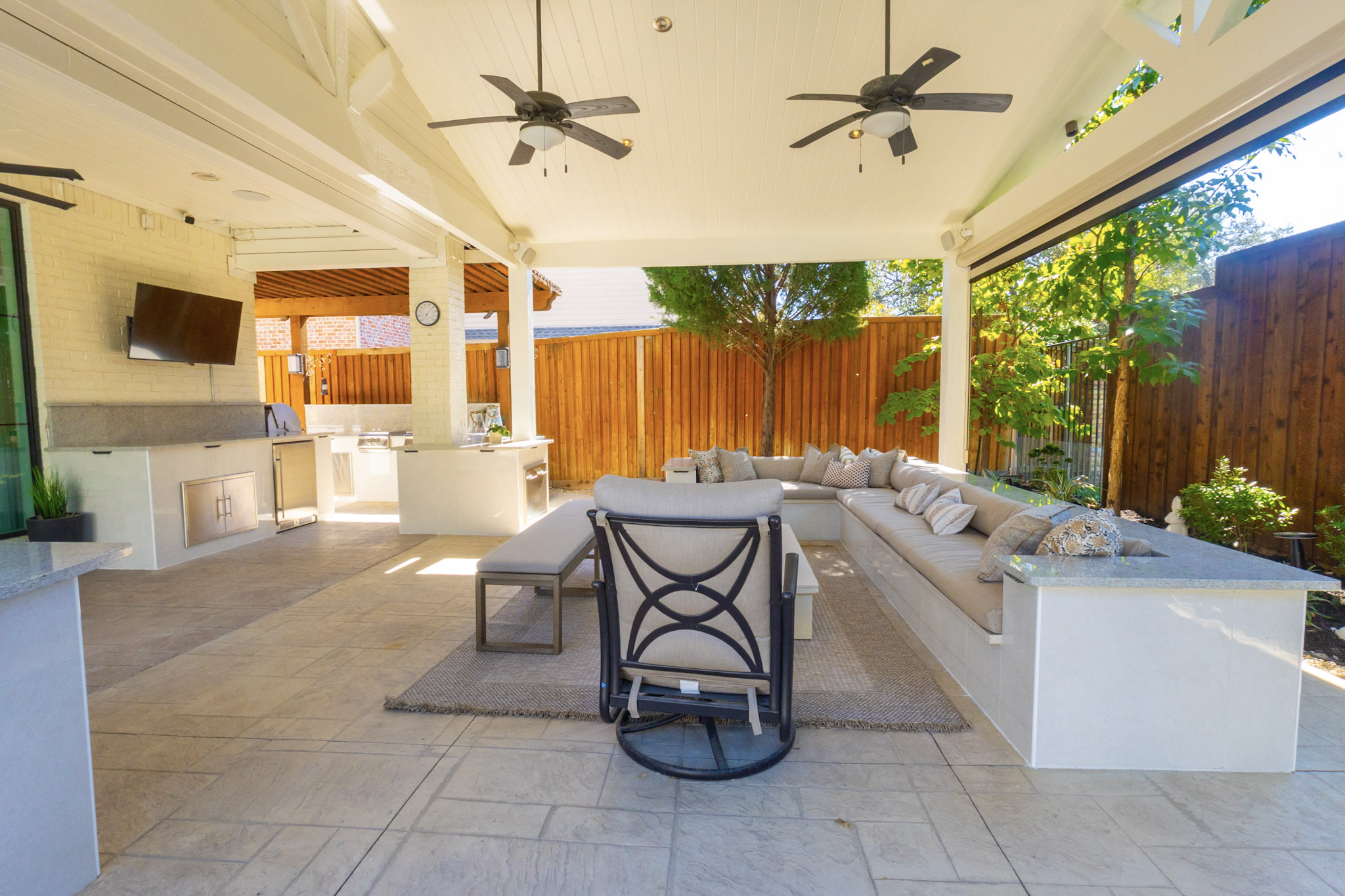 Stainless outdoor grill built into covered patio kitchen